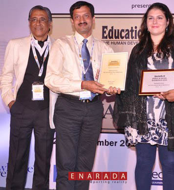 KiiT-IS Principal Mr Sanjay Suar and Head International Curriculum Ms Emma Pacilli receiving an award in Delhi. Dilip Thakore,Founder Editor of Education World looks on.