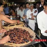 Serving devotees ‘appa’ prasadam at Sowthadaka teemple. eNarada